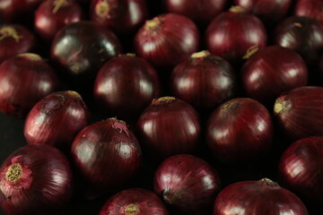 sweet red onions on background
