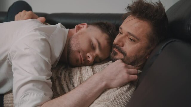 Young man sleeping in the arms of his boyfriend. Happy homosexual relationship. High quality 4k footage