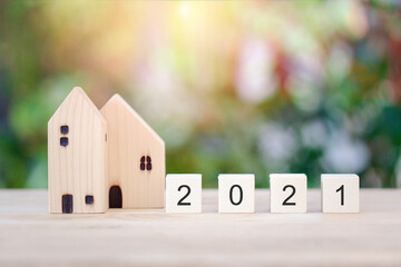 Obraz na płótnie Canvas Wooden cube block 2021 number, New Year concept, new house, plan for future on bokeh background.