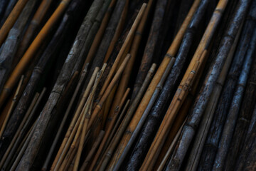 stacked bamboo and wood canes