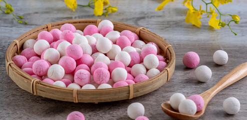 Raw red and white tangyuan on wooden table background for Winter solstice food.
