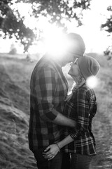 Cheerful guy with a board and a blonde girl for a walk in plaid shirts