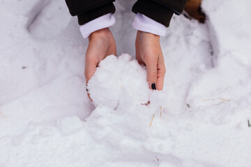 Woman's hands catching snow