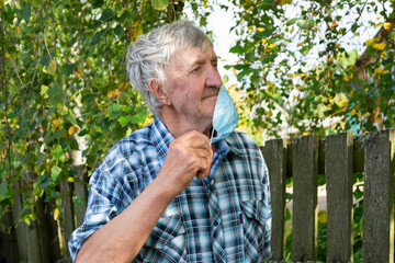 .portrait of an elderly man wearing a medical mask