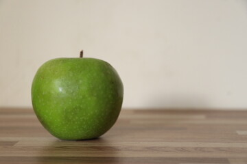 green apple on neutral background.