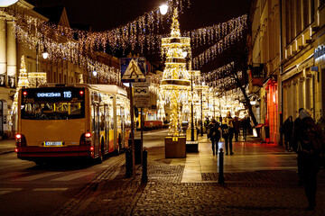 Fototapeta na wymiar streets at night with decorations for Christmas Warsaw Poland in the city center