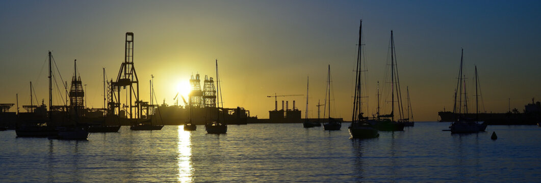 Panoramic view of the bay at sunrise with sailboats and port in the background, Las Palmas of Gran Canaria, Spain