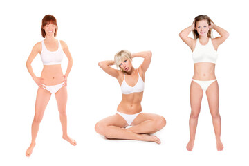 Full length portraits of three attractive young women wearing bikinis, isolated on white studio background