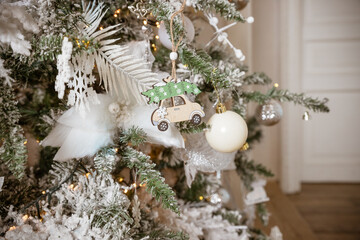 Christmas ornaments, silver snowflake, white balls, wooden toys on a Christmas tree close-up.Merry Christmas and New Year background. Toned image.retro balls, garlands on a spruce branch