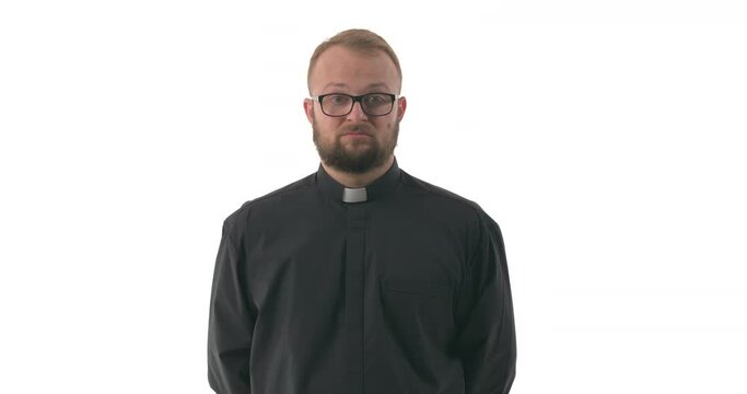 Shot of strict Caucasian priest looking at camera and calling someone with forefinger. Beckoning sign. Come here. Isolated on white background
