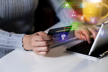 Digital banking and online payment concept. Hand holding credit card and network interface icons.
