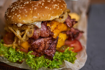 Juicy delicious burger on a wooden Board