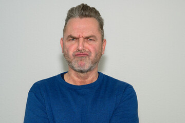 Disgruntled older man with puzzled expression - obrazy, fototapety, plakaty
