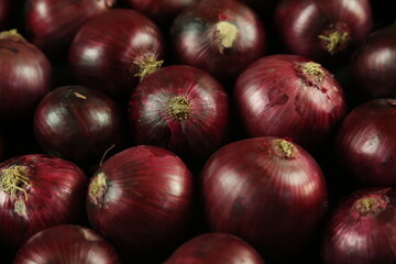 sweet red onions on background