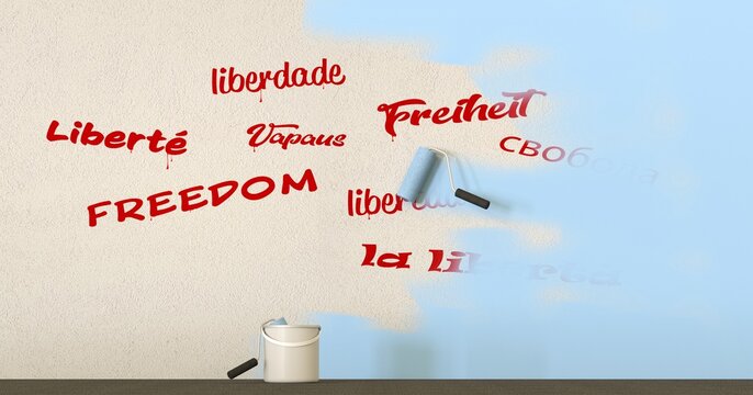 words freedom written in different languages on a wall covered with paint