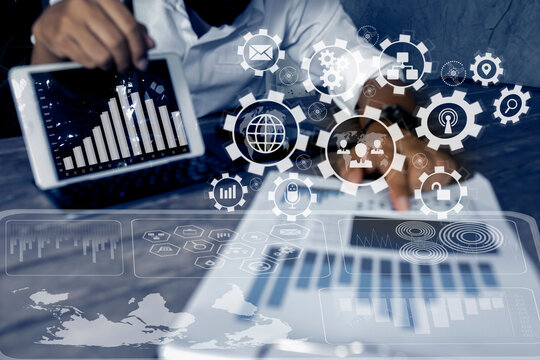 Business hand using tablet and showing a growing virtual hologram of statistics graph chart, Finance business planing and technology strategy concept.
