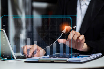 Hands of business people working with documents and digital network and stock exchange market with with graphs analysis candle interface icons on table office. 