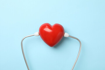 Blue stethoscope and heart on blue background