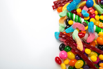 Multicolored assortment of candies. Background of sweets and lollipops and colorful array of different treats 