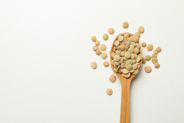 Wooden spoon with legumes on white background, space for text