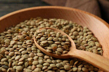 Kitchen towel, bowl and spoon with legumes, close up