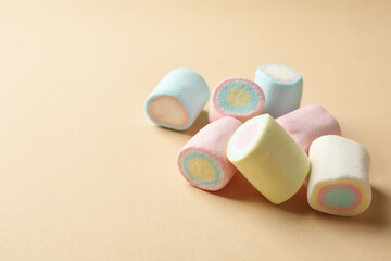 Sweet marshmallow on beige background, space for text