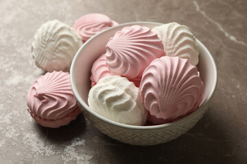 Bowl with sweet marshmallow on gray table