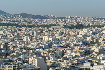 Fototapeta na wymiar Aerial view of cityscape with crowded buildings of Athens in a sunny day in Greece