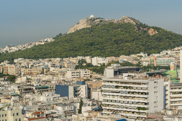 Fototapeta na wymiar Aerial view of cityscape with crowded buildings of Athens from a top of hotel in a sunny day in Greece