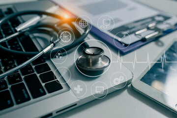 Stethoscope on laptop keyboard and technology digital interface icons.