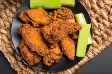 Top view of Fried chicken wings on plate. Breaded Crispy fried chicken tasty dinner.