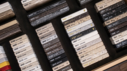 Decorative artificial stone in samples. Suitcase with samples of artificial stone. Finishing material, interior renovation. Gomel / Belarus / 18.12.2020 year