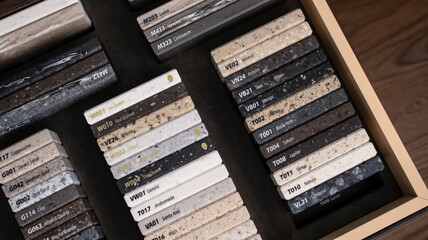 Decorative artificial stone in samples. Suitcase with samples of artificial stone. Finishing material, interior renovation. Gomel / Belarus / 18.12.2020 year