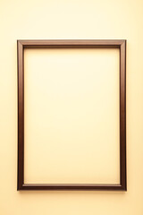 Brown frame on beige background. Creative Flat lay Top view Mockup Copy space for text.