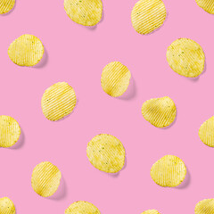Seamless pattern made from Potato chips on pink background flat lay. potato snack chips isolated Fast food banner.
