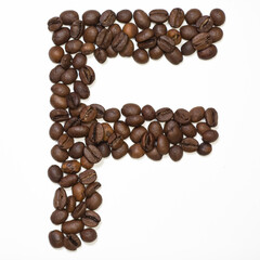 Symbol F, the letter of an aphovite made of coffee. Coffee background, letter F