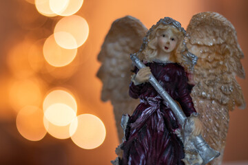 Christmas angel statue witch background bokeh lights
