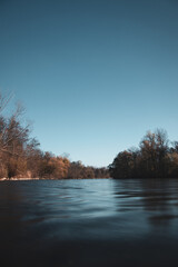 Dark deep water landscape. Deep river with moody colors.