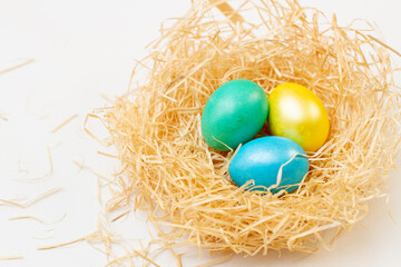 Fototapeta na wymiar Colorful easter eggs in basket on white background
