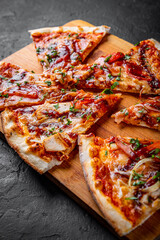 slice of Pizza with chicken and barbeque sauce. Italian pizza on Dark grey black slate background