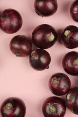 sweet red onions on background