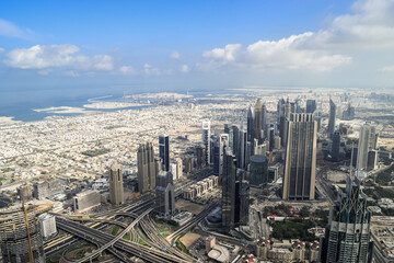 Fototapeta na wymiar View of Dubai from the top of Burj Khalifa. The sky is blue.