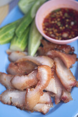 Charcoal-boiled pork neck served with spicy dip and vegetable.