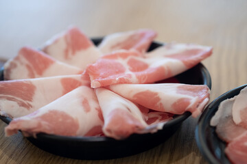 Fresh of thinly sliced of raw pork for hot pot. Japanese food style.
