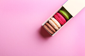 Close up of colorful french macaroons in gift box on pink background. Almond cookies.Top view. Valentine's day sweet gift concept,holiday, celebration.