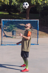 soccer player giving head hits to the ball