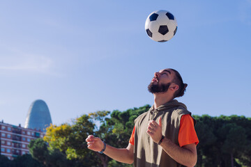 football player giving head hits to the ball