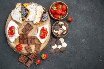 top view cake slices with chocolate bars and cookies on dark background fruit pie sweet