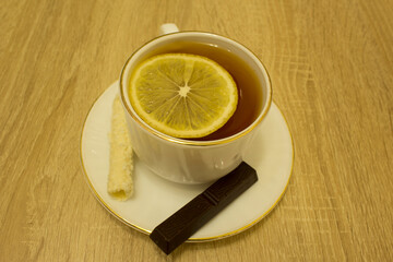 tea in a mug with lemon and sweets 