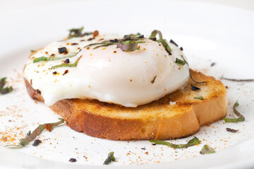 poached egg on toast on a white plate
